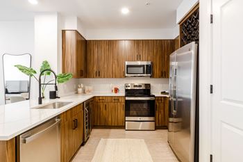 A kitchen with wooden cabinets and stainless steel appliances